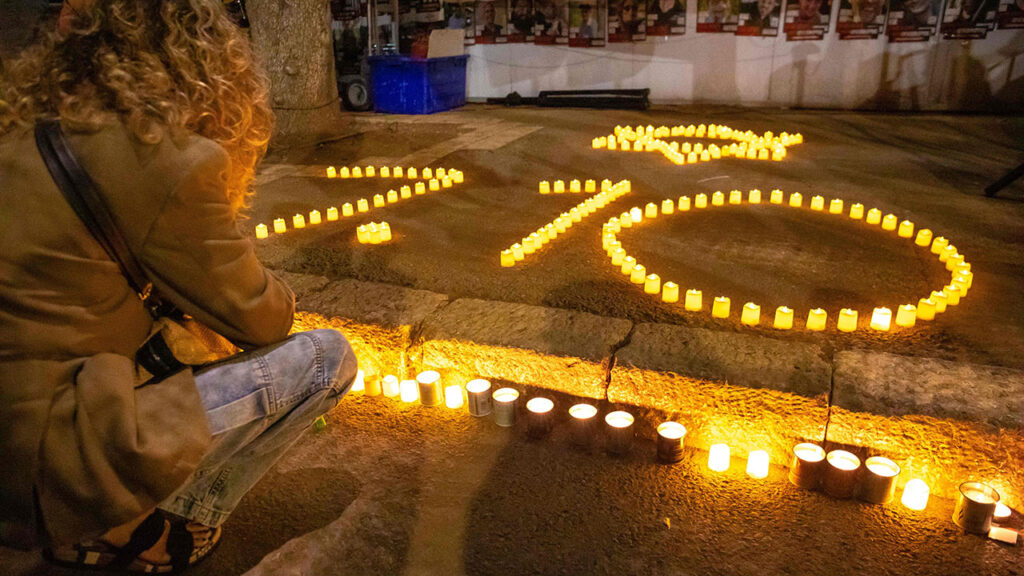 11/07/23 Jerusalem; Israel. A demonstrator lights a candle next to candles in the shape of the 10/7