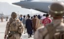 U.S. Marines guide evacuees on to a U.S. Air Force pIane during an evacuation at Hamid Karzai International Airport in Kabul, Afghanistan, on August 21, 2021. (Photo via U.S. Marines on Twitter)