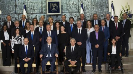 JERUSALEM, ISRAEL - JUNE 14:  Israeli President Reuven Rivlin (front row, centre) sits next to Israeli Prime Minster Naftali Bennett (front row, left) and Foreign Minister Yair Lapid (front row, right) as they pose for a group photo with minsters of the new Israeli government on June 14, 2021 in Jerusalem, Israel. A disparate coalition of parties forged a governing coalition to end Benjamin Netanyahu's 12-year prime ministership and two years of inconclusive elections.  (Photo by Amir Levy/Getty Images)