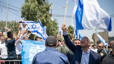Itamar Ben Gvir, head of the far-right Otzma Yehudit party, waves an Israeli flag during a demonstration at Nabi Samuel in the West Bank, on September 2, 2022. (Photo by Matan Golan/SOPA Images/LightRocket via Getty Images)