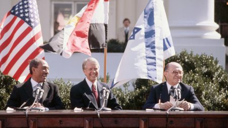 Egyptian president Anwar el-Sadat, US President Jimmy Carter, and Israeli Prime Minister Menachem Begin sit together in the sunshine outside the White House on March 26, 1979, ready to sign the peace treaty based on the Camp David Accords of September 1978. (Photo by Wally McNamee via Getty Images)