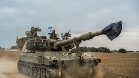 Israeli soldiers on a tank are seen near the Israel-Gaza border on October 9, 2023. (Photo by Ilia Yefimovich/picture alliance via Getty Images)