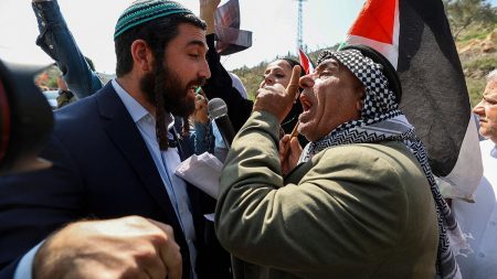 An Israeli settler and a Palestinian argue during a demonstration in support of Palestinians in Huwara in the West Bank city of Nablus on March 3, 2023. (Photo by Issam Rimawi/Anadolu Agency via Getty Images)