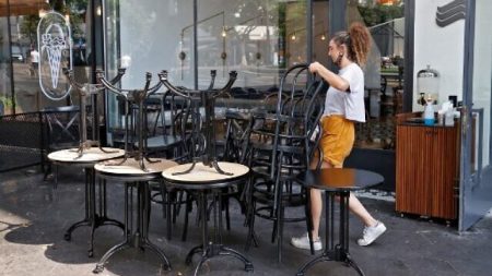 An employee puts away the furniture of a restaurant in the coastal city of Tel Aviv on September 18, 2020, ahead of a nationwide lockdown to tackle a spike in coronavirus cases. - Israel imposed a second nationwide lockdown today to tackle one of the world's highest coronavirus infection rates, despite public protests over the new blow to the economy.
The three-week shutdown will start just hours before Rosh Hashana, the Jewish new year, and will extend through other key religious holidays, including Yom Kippur and Sukkot. (Photo by JACK GUEZ / AFP)